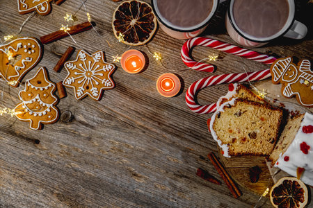 Festive gingerbread figures near candles and candies