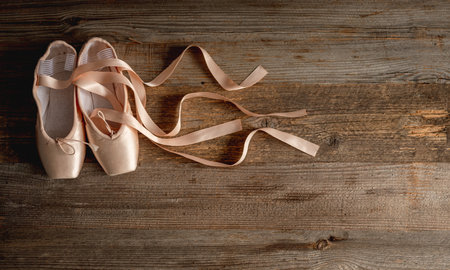 Pointe shoes with ribbons on wooden backgroundの写真素材