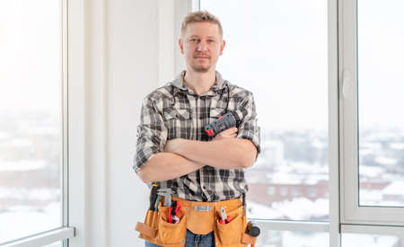 Young caucasian worker with tool beltの写真素材