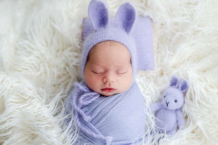 Cute newborn wearing hat with hare earsの写真素材