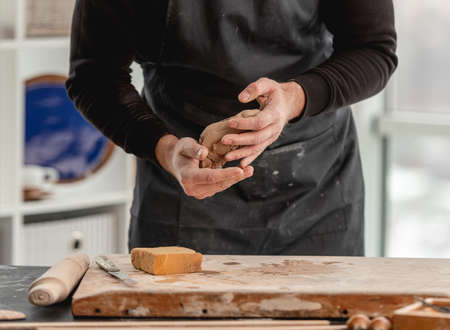Man potter molding clay at workshopの写真素材