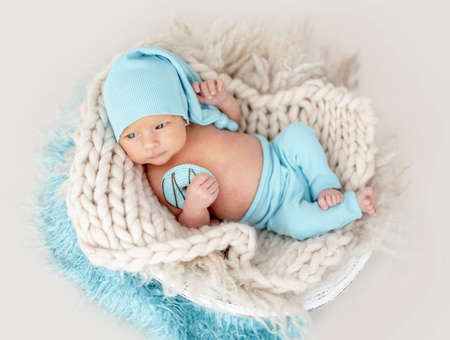 Newborn baby boy with knitted toyの写真素材