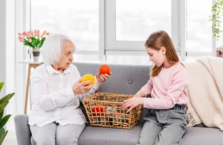 Grandmother teach to knit granddaughterの写真素材