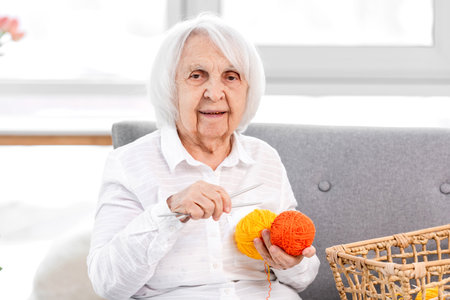 Elderly woman with needles and threatの写真素材