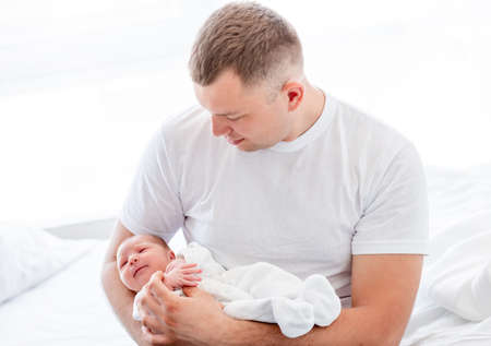 Father with newborn daughterの写真素材