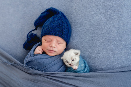 Newborn sleeping with kitten