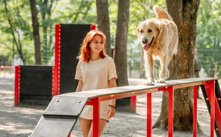 Girl with golden retriever dog