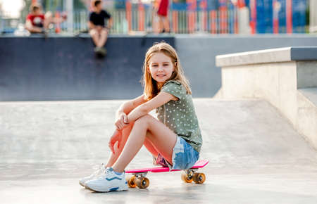 Girl with skateboard outdoorsの写真素材