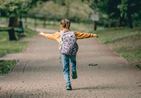 Schoolgirl with backpack outdoorsの写真素材