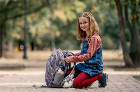 Preteen school girl with backpack