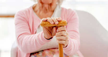 Senior woman with walking stickの写真素材