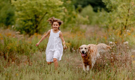 Girl with golden retriever dogの写真素材