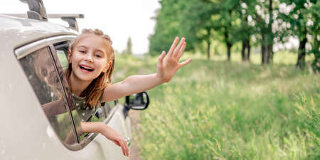 Preteen girl with car at the natureの写真素材