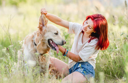 Teen girl with golden retriever dogの写真素材
