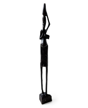 Traditional black figurine from Tanzania isolated on white background. Carving handicraft human statuette souvenirの写真素材