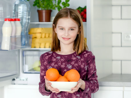 Preteen girl at kitchenの写真素材