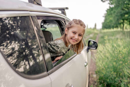 Preteen girl with car at the natureの写真素材