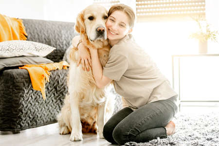 Pretty girl with golden retriever dog