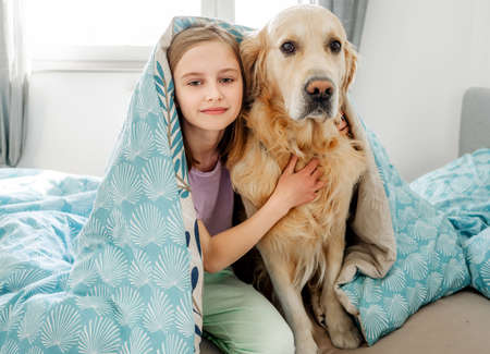 Little girl with golden retriever dog