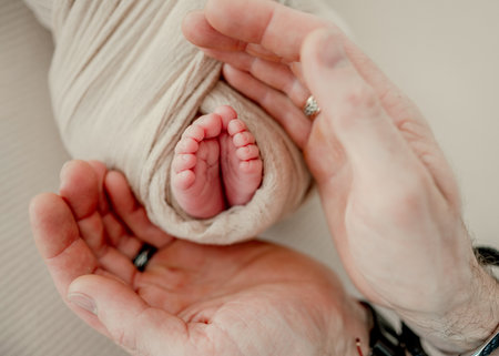 Father holding little babys legsの写真素材