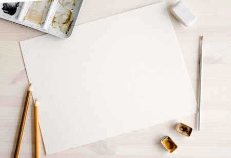 Watercolor paper blank with paint pallete and brush artist set. Aquarelle drawing canvas template with copy space and paintbrush for craft hobbyの写真素材