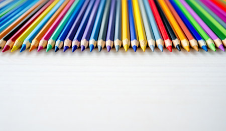 Colorful pencils lying on watercolor paper closeup. Multicolor crayons pallete for artist inspiration and hobbyの写真素材