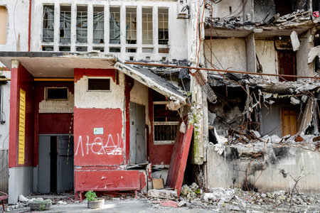 Destroyed building after russian missle rocket attack during war in Ukraine. House ruins with word People in residential neighborhood in city Kharkivの写真素材