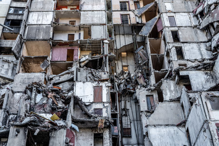 Destroyed residential building with apartments after russian missle rocket attack during war in Ukraine closeup. House ruins in city Kharkivの写真素材
