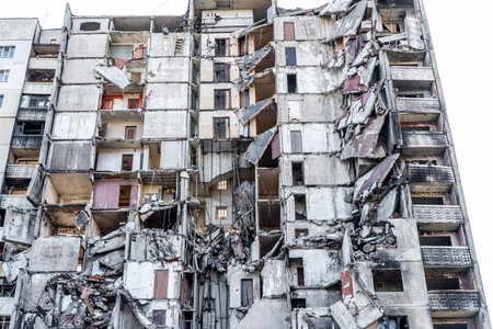 Destroyed residential building wall after russian missle rocket attack during war in Ukraine. House ruins in Kharkiv after terrorist agressionの写真素材