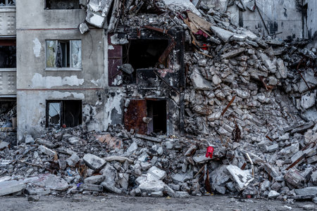 Destroyed residential building wall after russian missle rocket attack during war in Ukraine. House ruins in Kharkiv after terrorist agressionの写真素材