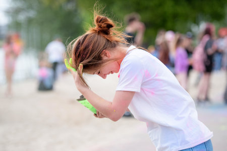 Pretty girls in indian traditional Holi festival with colorful powder having fun. Female teenager and preteen child enjoying positive holiday of Indiaの写真素材