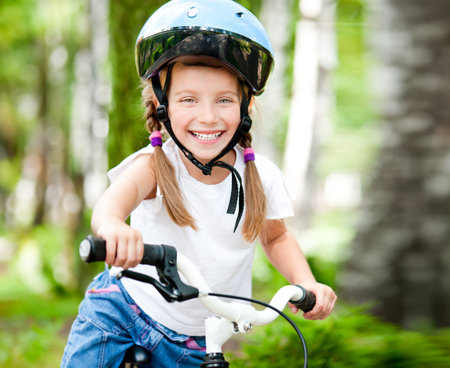little girl with her bicycleの写真素材