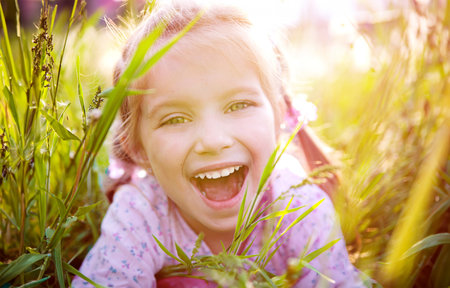 Cute little girl on the meadow in spring dayの写真素材