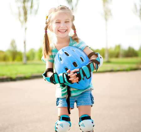 Little girl in roller skates at a parkの写真素材