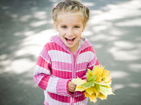 Cute small girl. Autumn portraitの写真素材