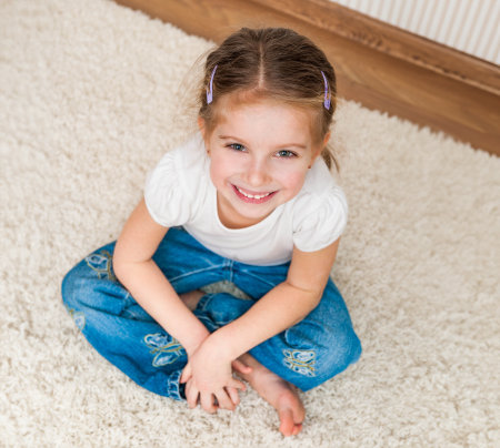cute little girl sitting on the floor. top viewの写真素材