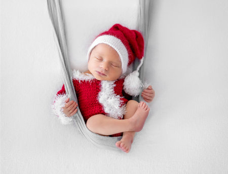 Newborn baby boy wearing Santa Christmas costume. Little infant child New Year xmas portraitの写真素材