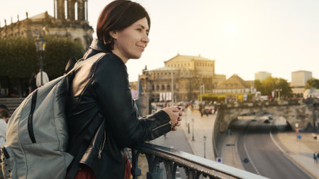 Young Woman Admires City View, With Blurred Cityscape In Autumn As Backdropの写真素材