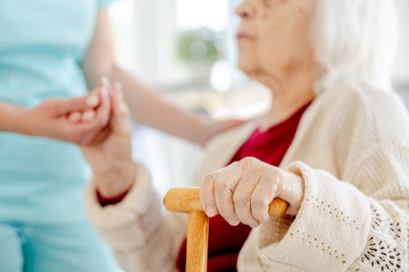 NurseS Hand Holding Elderly WomanS Hand With A Cane And NurseS Hand Holding Pills That Elderly Woman Is Taking, Are Captured In Close-Upの写真素材