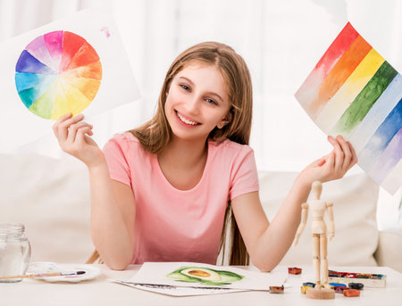 Fine girl is showing her current amazing watercolor painted rainbow collectionの写真素材