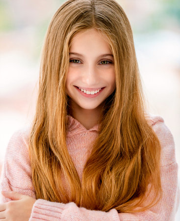 Cute long haired teenage girl smiling to cameraの写真素材