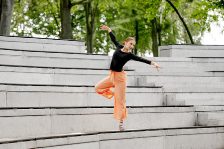 Sweet Girl Dances In Sandals At Amphitheater In Summerの写真素材