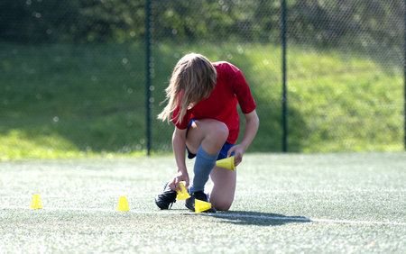 Girl Arranges Flip Cups At Football Practiceの写真素材