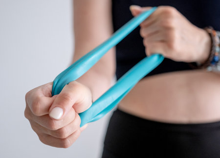 Woman Exercises With Resistance Band In Close-Up View