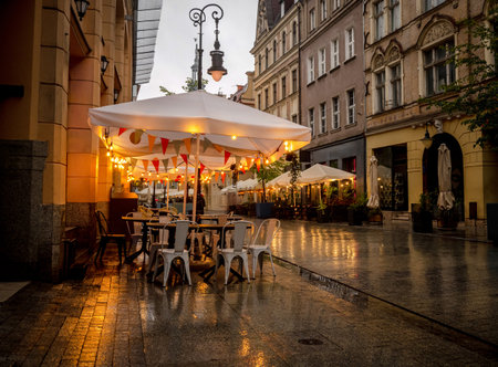 Street Cafe With Lights In The Evening On An Old Polish Street Exudes A Charming Ambianceの写真素材