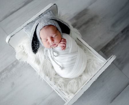Newborn Baby Sleeps In Crib During Photo Sessionの写真素材