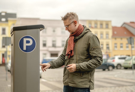 Man Using Parking Meterの写真素材