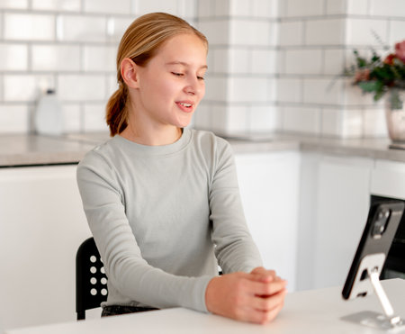 Cute Little Girl Talks Via Video Call Using A Smartphoneの写真素材