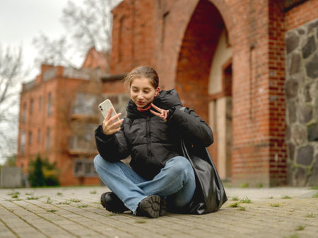 Girl Video Calling In Front Of An Old Tower In A European City