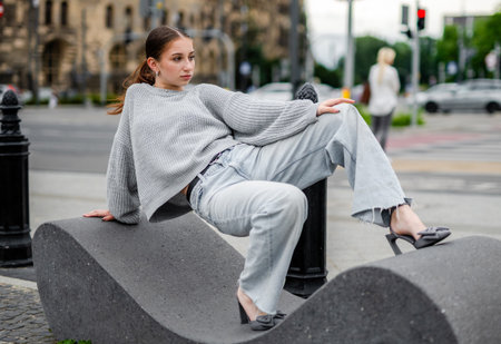 Model Posing While Sitting On A City Streetの写真素材